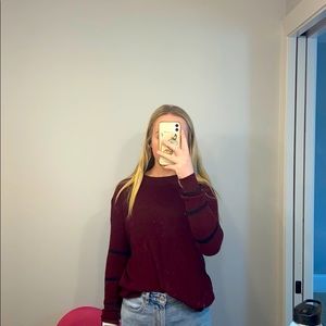 maroon sweater with black stripes on sleeves